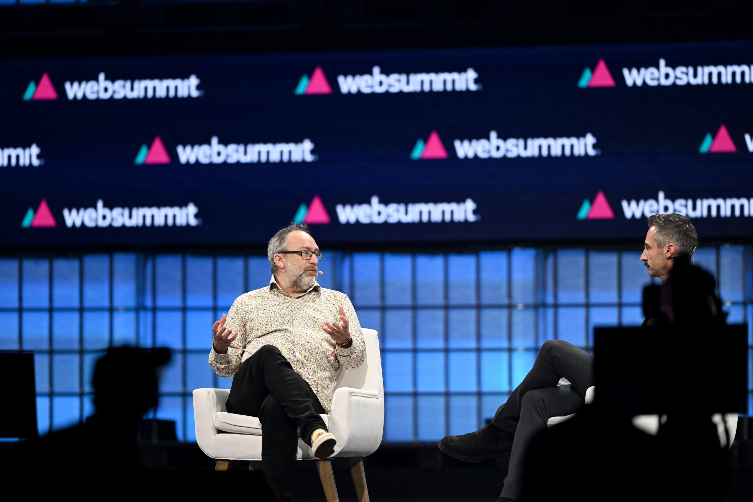 13 November 2023; Jimmy Wales, Founder, Wikipedia, left, and Ryan Heath, Global Technology Correspondent, Axios, on Centre Stage during the opening night of Web Summit 2023 at the Altice Arena in Lisbon, Portugal. Photo by Eóin Noonan/Web Summit via Sportsfile